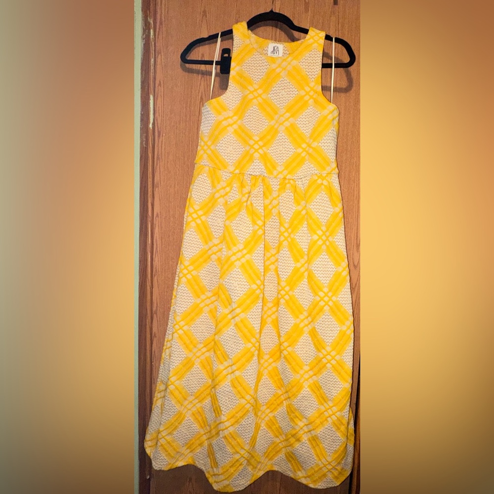 yellow and white diamond patterned dress by the brand Dra Los Angeles